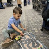 I designed and built my son a portable toy car busy board with an old binder