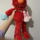 Can someone help me id this Elmo? found it at the thrift shop. It has blue gloves and a pink-white striped corduroy scarf.