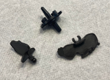 What are these plastic toy pieces? There are three pieces of plastic, likely for some sort of toy. The two brown pieces seem to have some sort of interlocking ball joint mechanism. One of the brown pieces have the engraving "EN497". The black piece seems to be some sort of top.