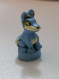 Tiny figurine of what looks like a blue and white canine with yellow eyes. It’s on a stand so I’m speculating it might be from a board game. I remember obtaining it in a bag of some early 2000’s Digimon figurines, so I think its safe to assume that it’s from that same time period.